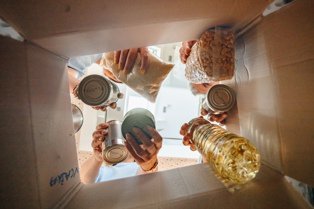 Donated essential items being placed into a box